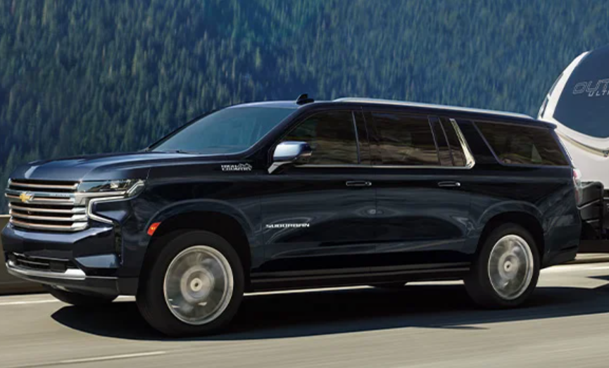 2024 Chevy Suburban Pulling Camper Along Mountains